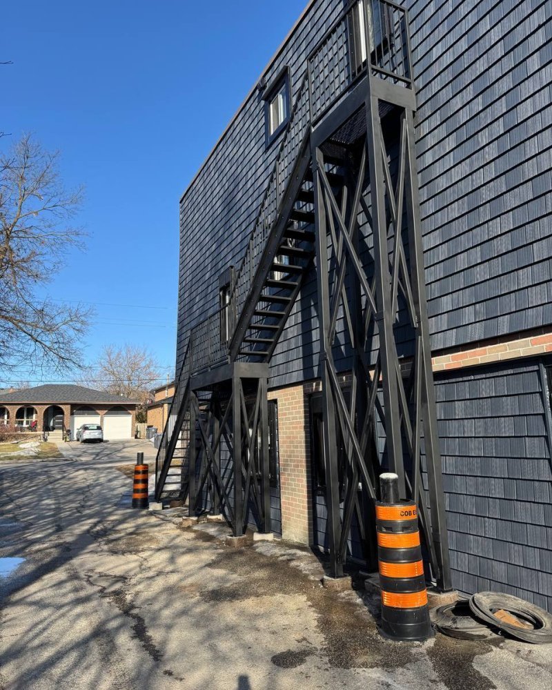 Galvanized exterior fire escape stair attached to a brick warehouse in Ontario
