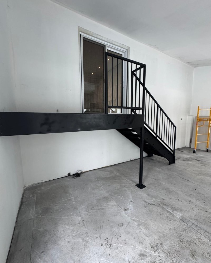 Single-flight steel straight-run stair installed for mezzanine access in an Ontario warehouse